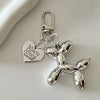 Silver heart-shaped cartoon dog keychain with a clasp and chain