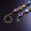 A multi-color enamel tennis chain necklace featuring various colored gemstones and gold-toned links.