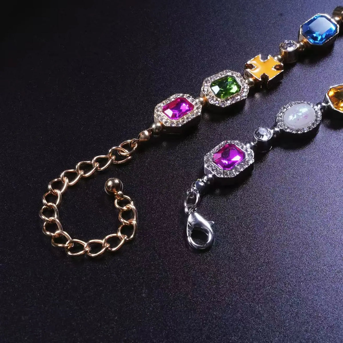 A multi-color enamel tennis chain necklace featuring various colored gemstones and gold-toned links.