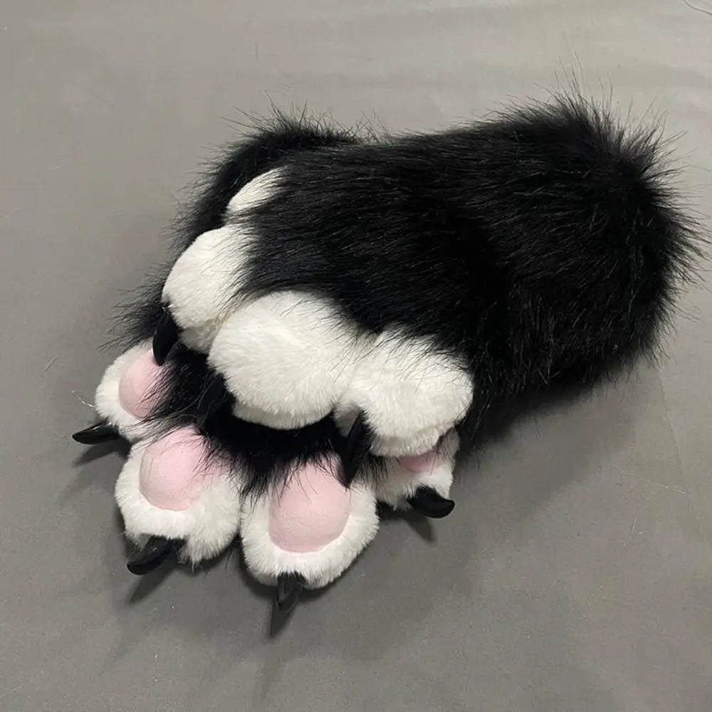 A pair of black and white cartoon cosplay furry gloves with pink accents.