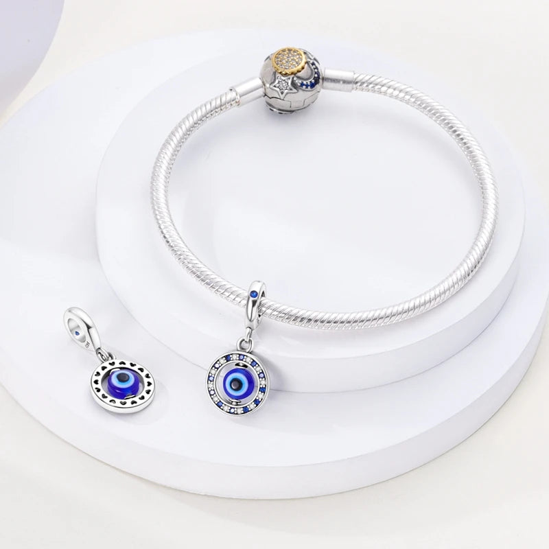 Sterling silver devil's eye charm bracelet with a round charm and a pendant