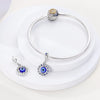 Sterling silver devil's eye charm bracelet with a round charm and a pendant