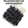 A pile of black satin hair scrunchies is shown on a cardboard backing.