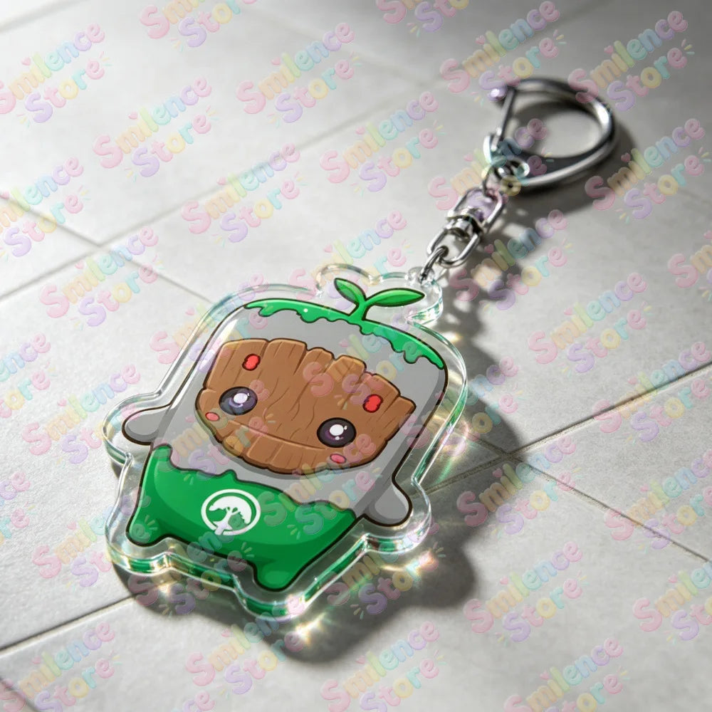 A clear acrylic keychain featuring a cute character design with green and brown elements.