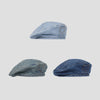 A close-up view of a retro washed cotton denim beret hat in blue.