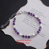 Sterling silver double heart charm bracelet featuring natural amethyst stones