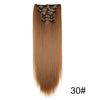 A bundle of long, straight, light brown hair extensions with black hair ties.