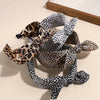 A collection of leopard print retro bow hairbands in various shades and patterns.