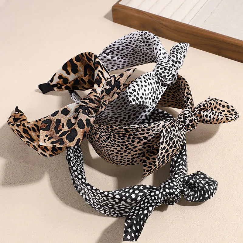 A collection of leopard print retro bow hairbands in various shades and patterns.