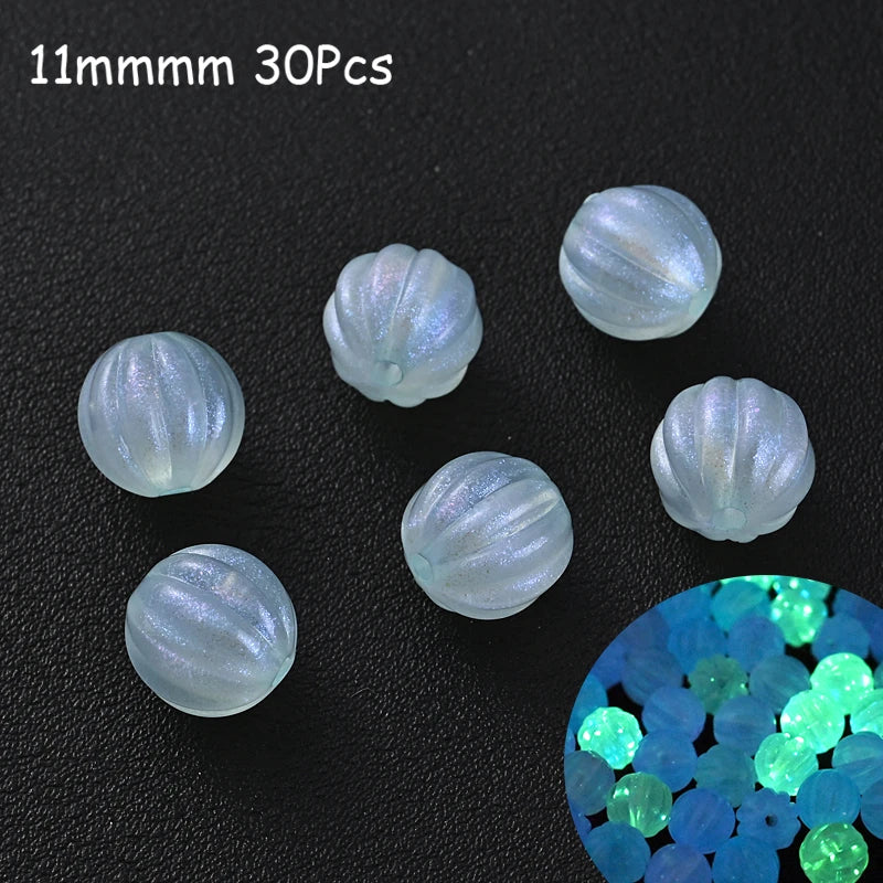 A collection of 30 iridescent glow-in-the-dark acrylic beads scattered on a dark surface.