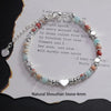 Sterling silver double heart charm bracelet featuring natural shoushan stone beads in pink and blue tones