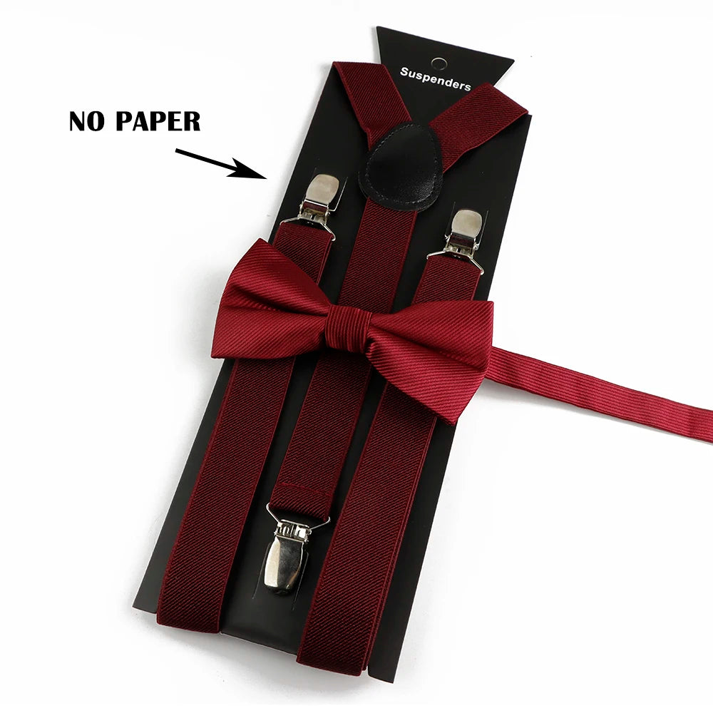 A set of adjustable red polyester suspenders and bow ties displayed on a black card.