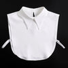 White blouse with a false collar and detachable neckline, displayed against a black background.