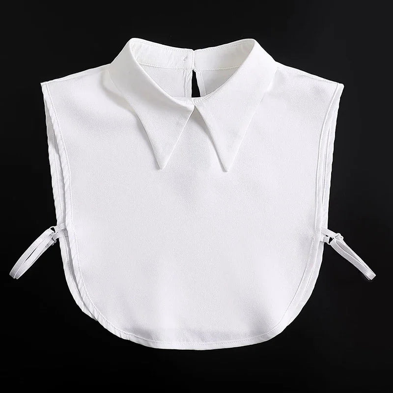 White blouse with a false collar and detachable neckline, displayed against a black background.