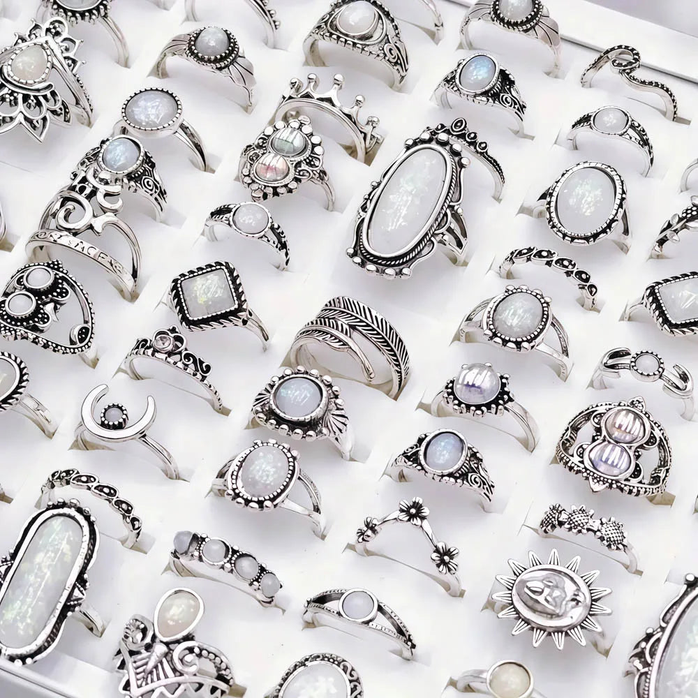 A collection of silver and gemstone charm rings for women displayed on a white background.
