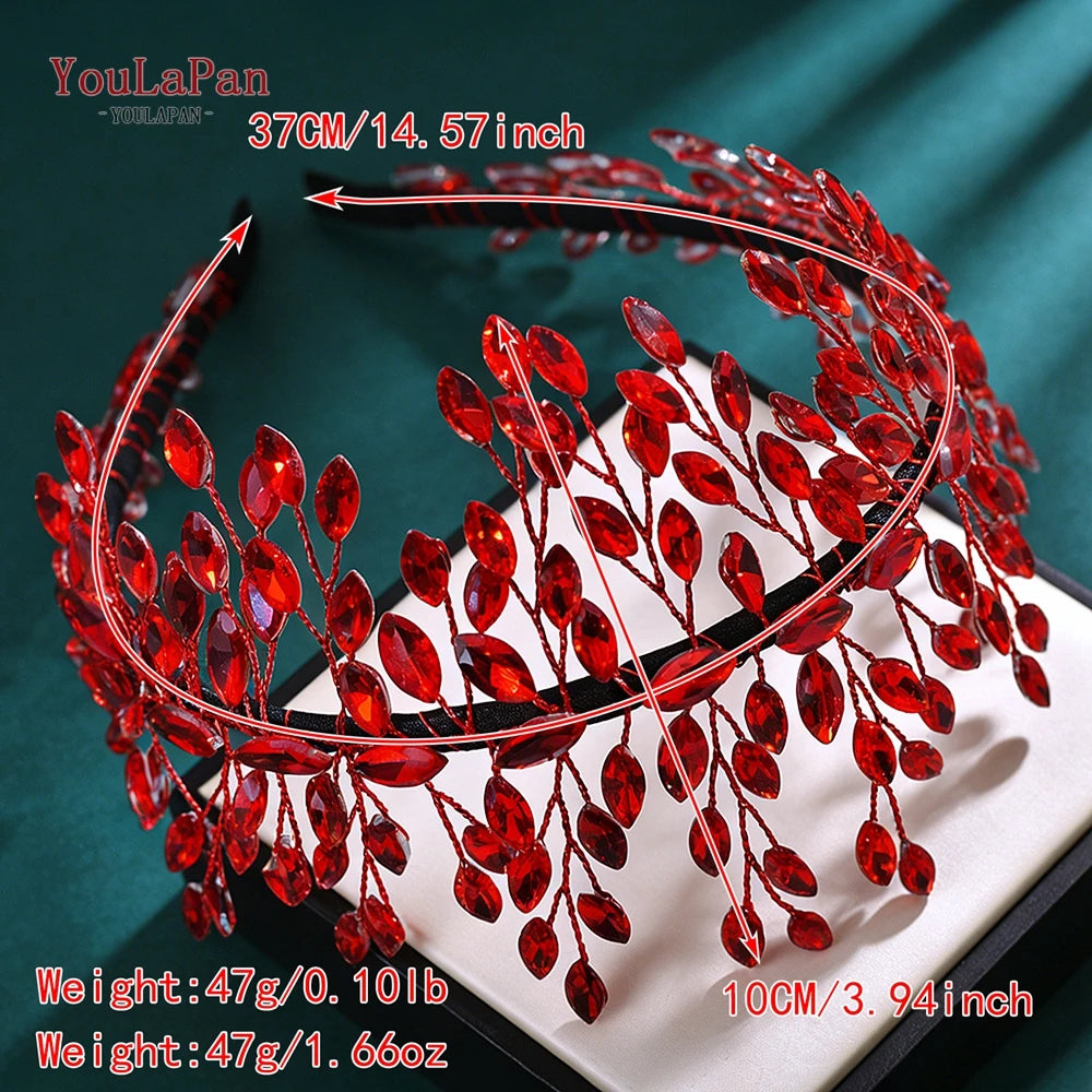 A close-up of a red rhinestone bridal headband featuring delicate leaves and berries.