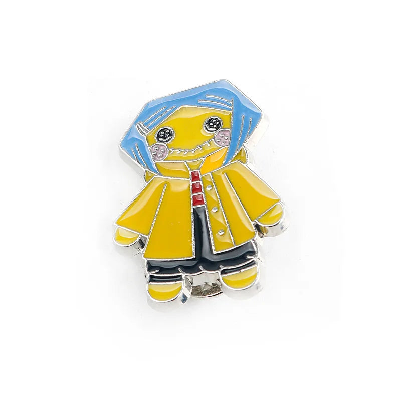 Broche émail jaune et bleu représentant un personnage de dessin animé stylisé avec de grands yeux
