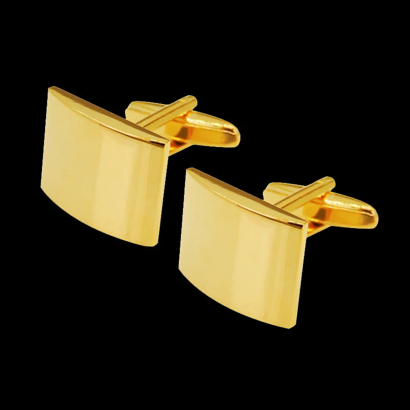 A pair of gold-toned square cufflinks with a classic design against a black background.