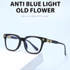 Black square anti blue light eyeglasses resting on a white surface.