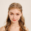 A young woman with long blonde hair wears an elegant pearl hair net headband.