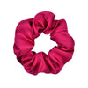 A vibrant magenta satin scrunchie tied in a voluminous, ruched style.