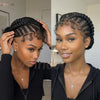 A close-up photo of a woman with braided cornrows on her head, looking directly at the camera.
