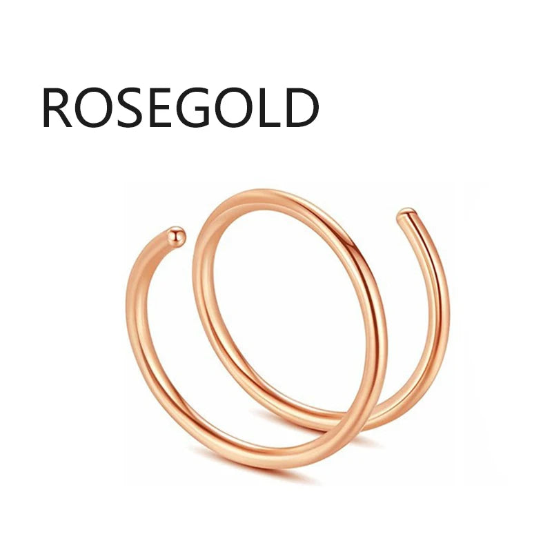 A close-up of a rose gold hoop nose ring jewelry piece.