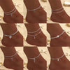 A series of images showing a sparkling zircon heart cross anklet worn on a woman's ankle.