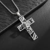 Silver cross amulet necklace with a detailed depiction of Christ's face and crown on a dark background.