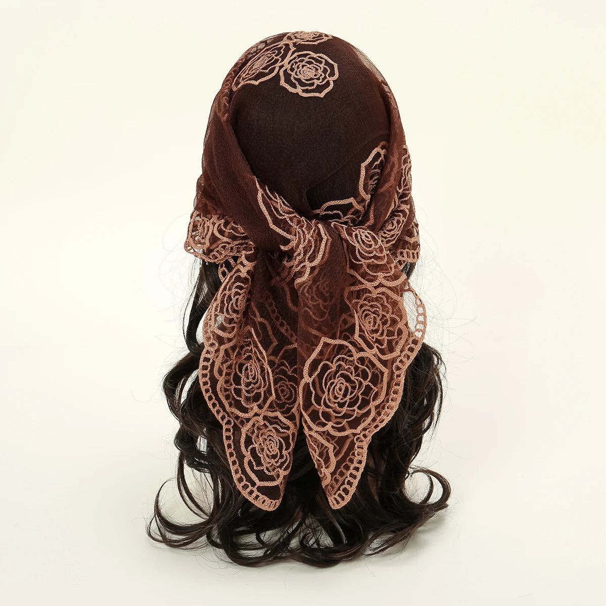 A dark brown floral embroidered lace bandana headscarf tied around dark hair.
