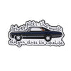 Broche émail noire représentant la silhouette d'une voiture de sport et le texte : Le pilote choisit la musique, le canon fer