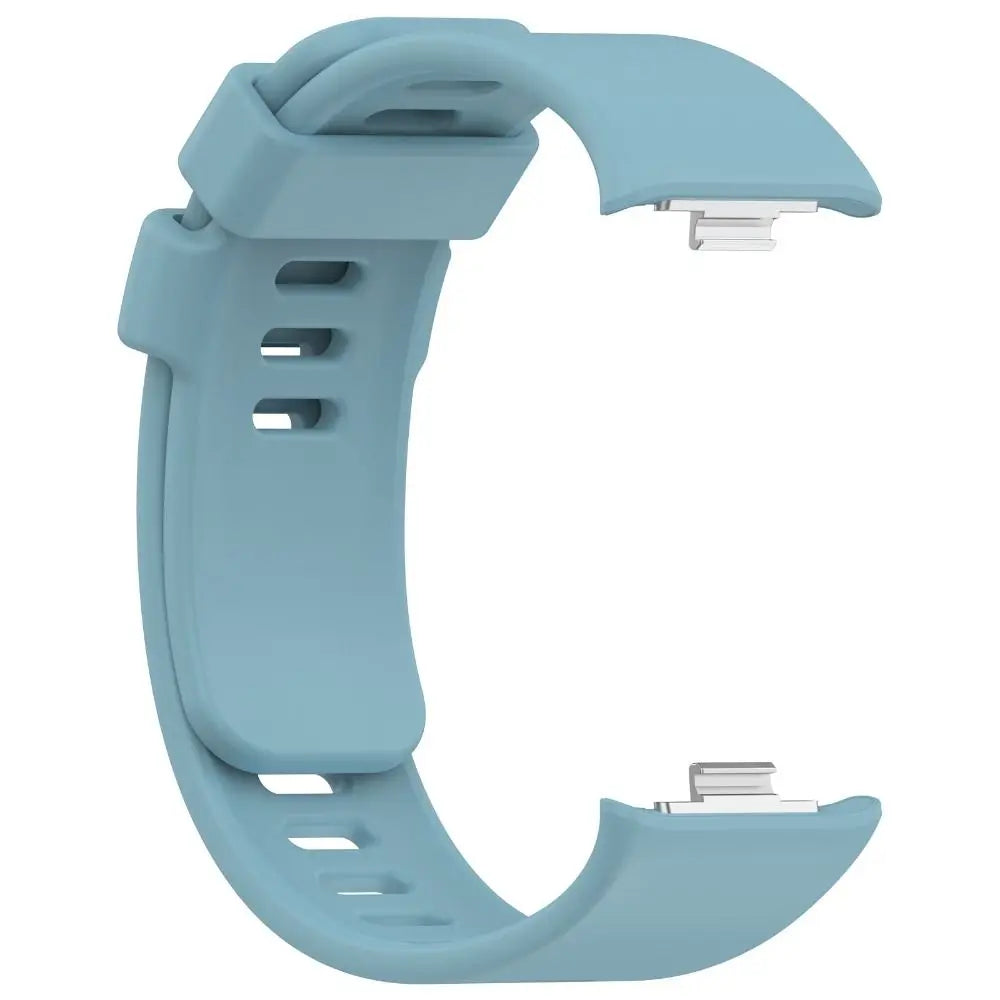 A light blue replacement silicone watch strap for a smartwatch, shown in a curved shape.