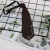 A dark brown classic chain necktie is displayed against a grid background of floral and nature images.