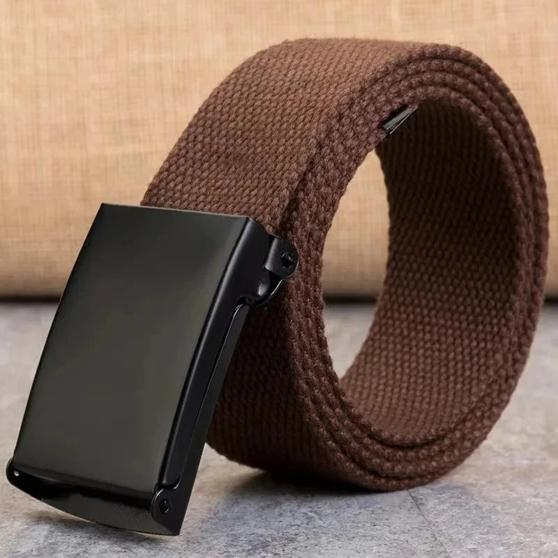 A black tactical canvas waist belt is shown coiled on a brown woven fabric background.