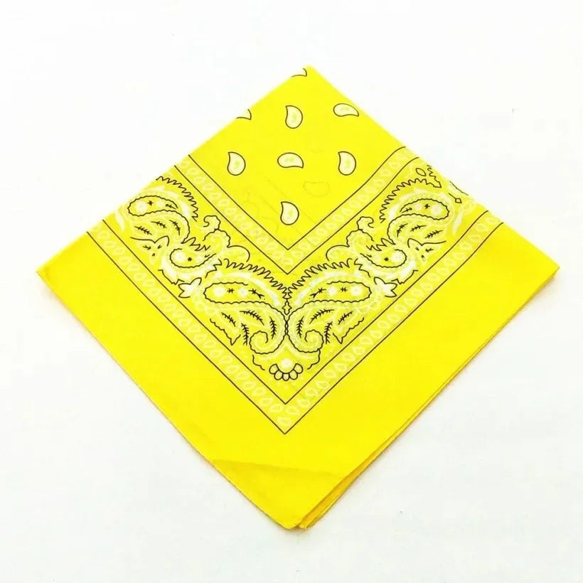 A bright yellow cotton bandana scarf featuring a delicate yellow paisley and floral print.