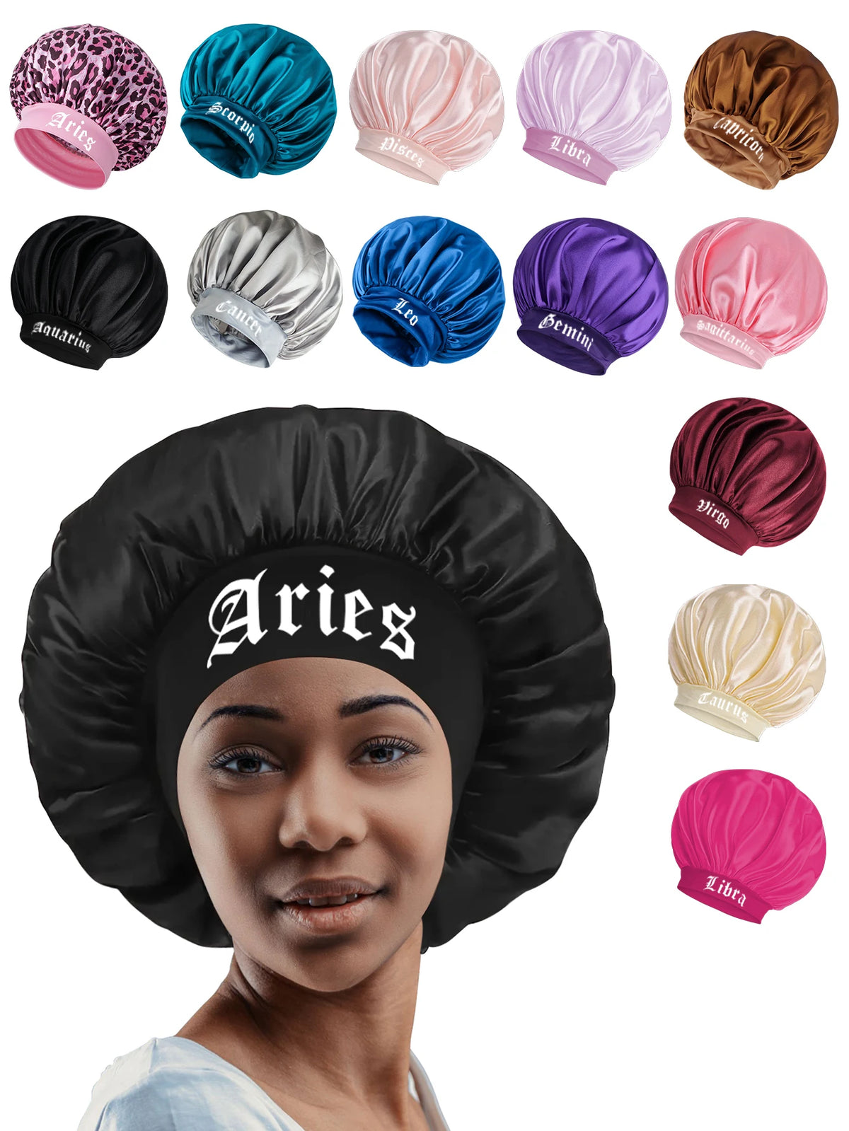 A woman wearing a black satin sleep bonnet with an Aries wrap band, surrounded by various colored satin bonnets.
