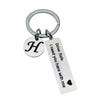 Silver keychain with a circular initial H charm and a tag that reads Drive Safe I need you here with me