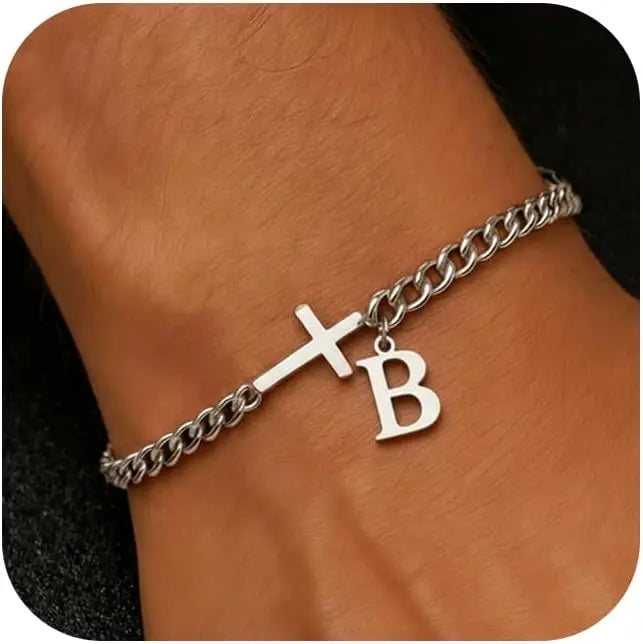 A close-up of a personalized stainless steel cross Cuban chain bracelet worn on a wrist.