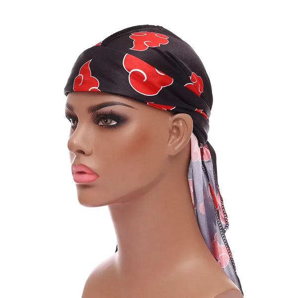 A black bandana headwrap with red cloud patterns worn on a mannequin's head.
