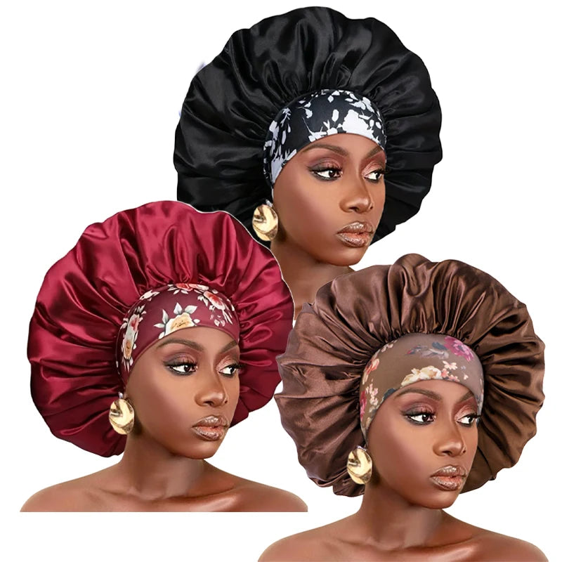 A model wears a black satin sleep bonnet with an elastic band and a floral patterned fabric.