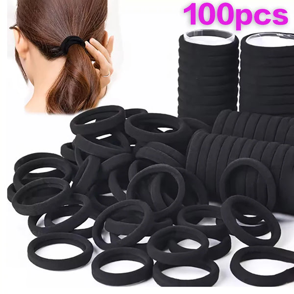 A pile of black seamless elastic hair ties and rollers for holding ponytails