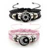 A pair of black and pink couple bracelets featuring sun and moon designs.