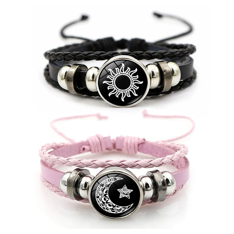 A pair of black and pink couple bracelets featuring sun and moon designs.
