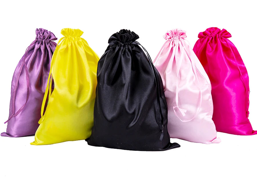 Five satin wig storage bags in purple, yellow, black, pink, and magenta with drawstrings.