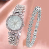 Silver rhinestone quartz watch and bracelet set displayed on a pink background