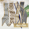 A set of four silk satin hair and bag accessories featuring rhombic lattice, florets, and houndstooth patterns.