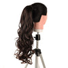 A dark brown synthetic hair extension styled in a long, wavy ponytail mounted on a hair display stand.