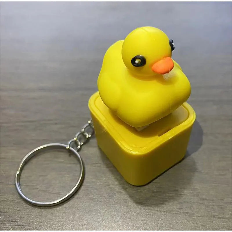 A yellow rubber duck fidget toy attached to a silver keyring.