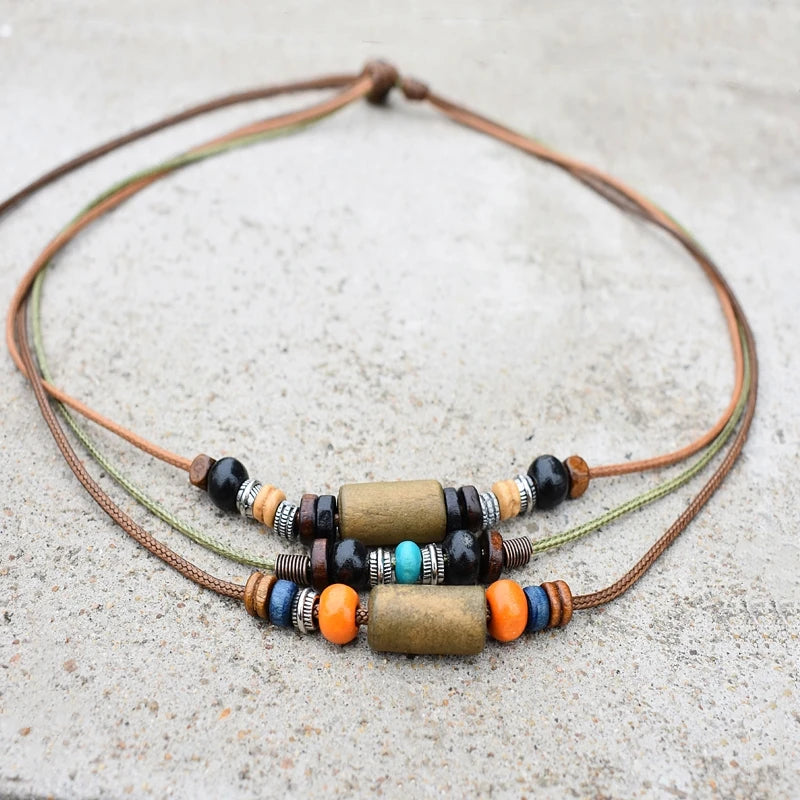 A set of boho vintage wood and stone bead necklaces on a brown leather cord.