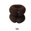 A pair of dark brown, elastic gauze tools used for creating hair buns.